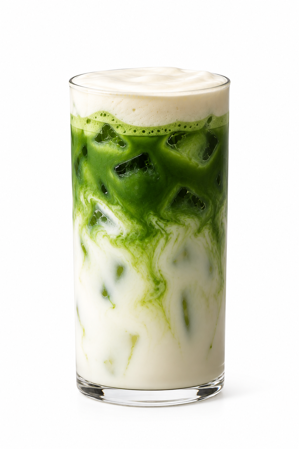 Iced matcha latte with swirling green matcha through milk and ice, in a tall glass on a white background