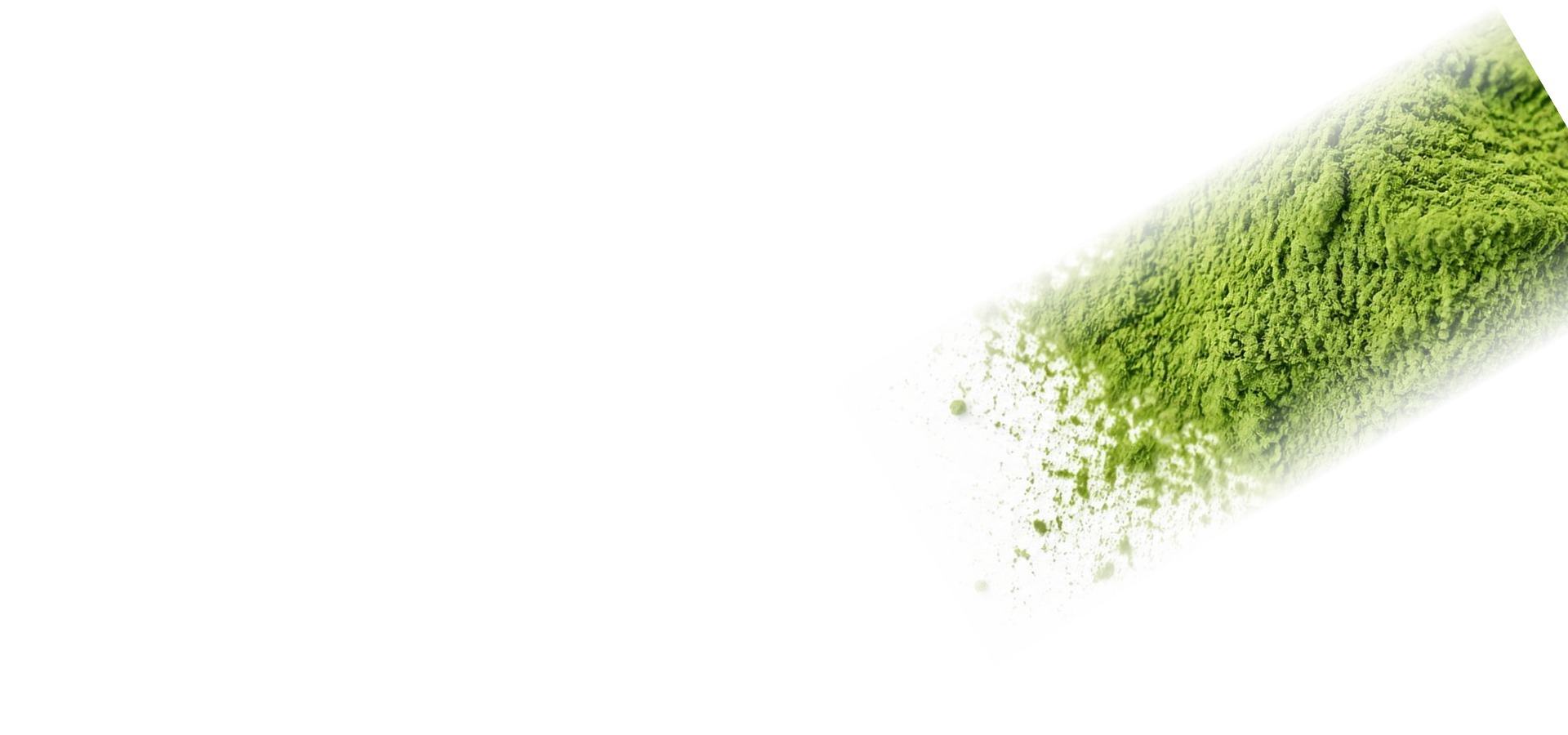 Bright green matcha powder scattered on a white surface